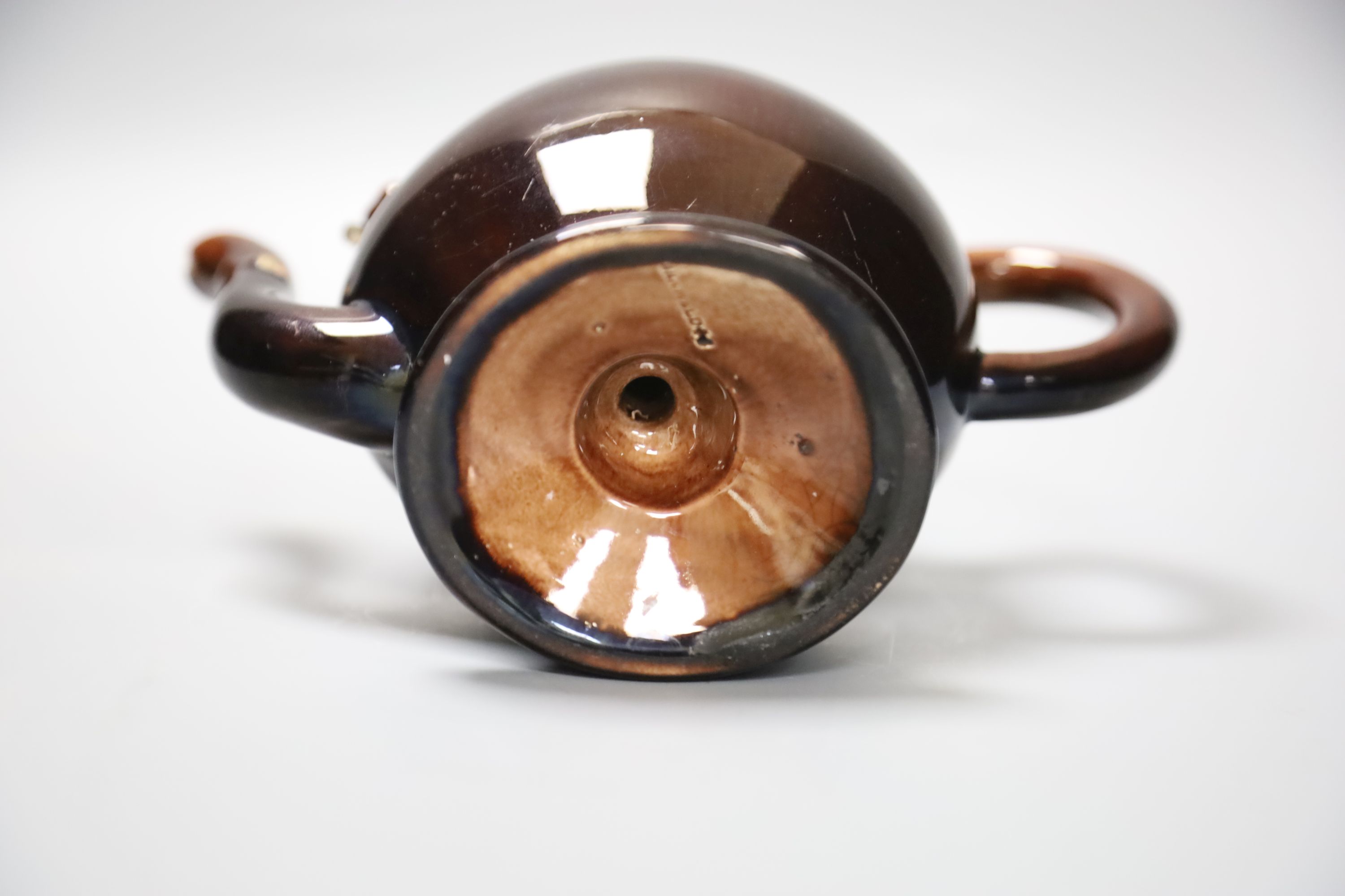 A small Brameld Cadogan teapot, relief moulded and gilded over a brown glaze, impressed mark, height 15cm, minor spout chip